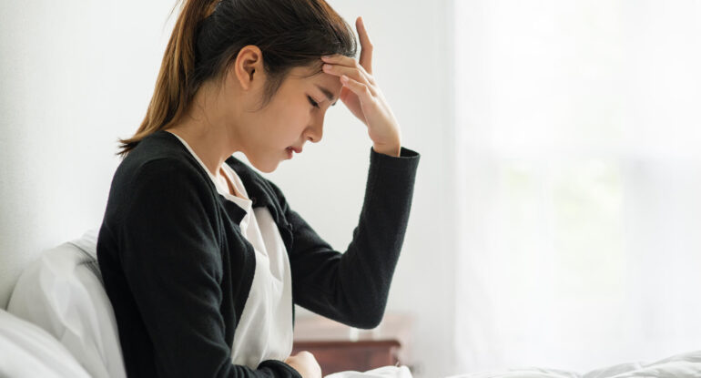 Sick woman had headache hands touched her head bed